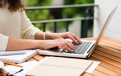 Person learning on laptop with course materials